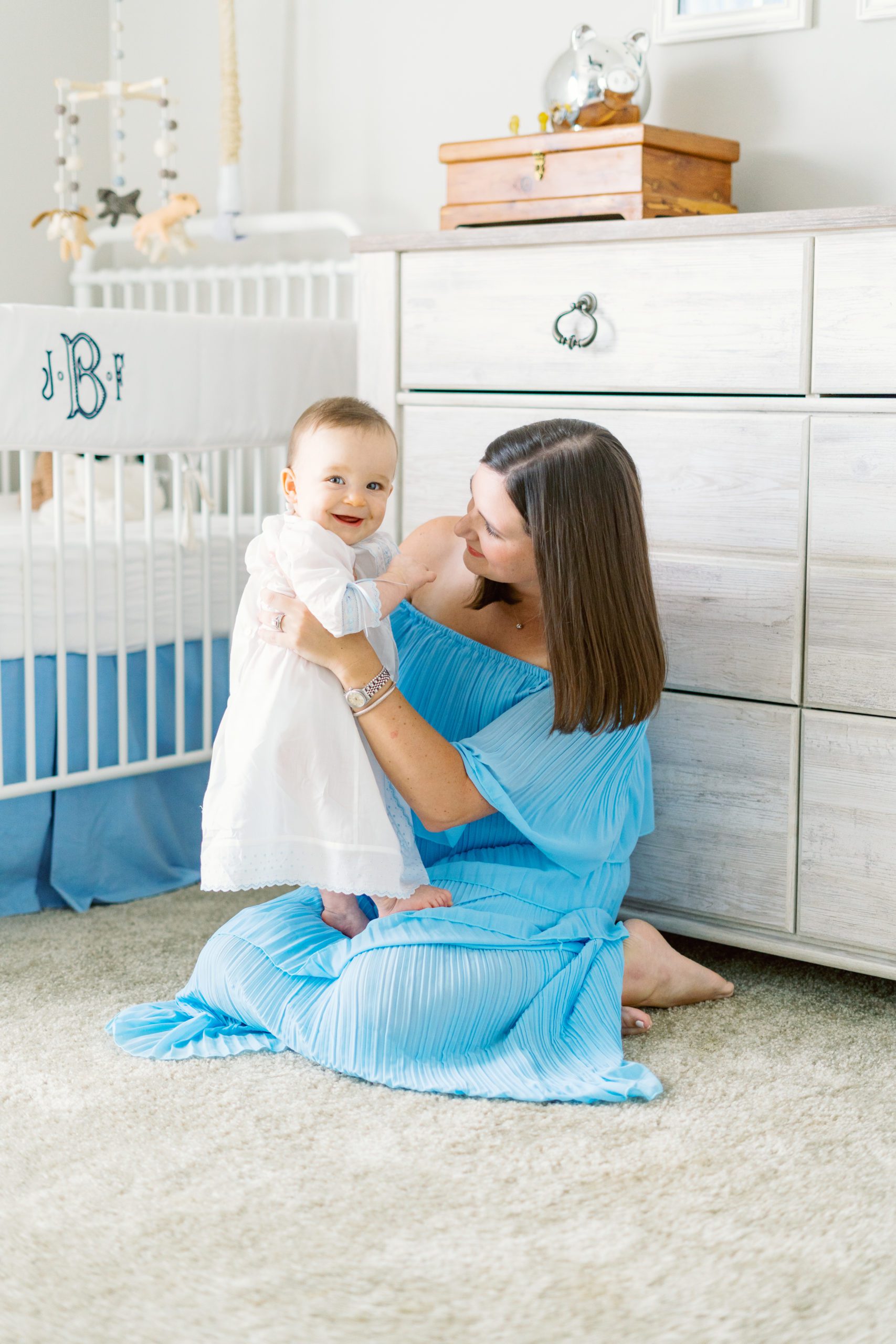 mom holding baby in cute southern chic nursery